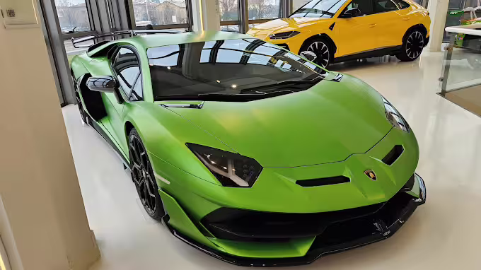 Vibrant green Lamborghini sports car showcased alongside a yellow model at the Lamborghini Museum in Bologna.