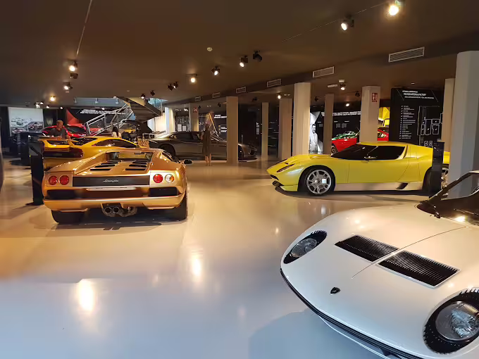 Wide view of Lamborghini Museum gallery near Modena with vintage supercars, Bologna day trip entry
