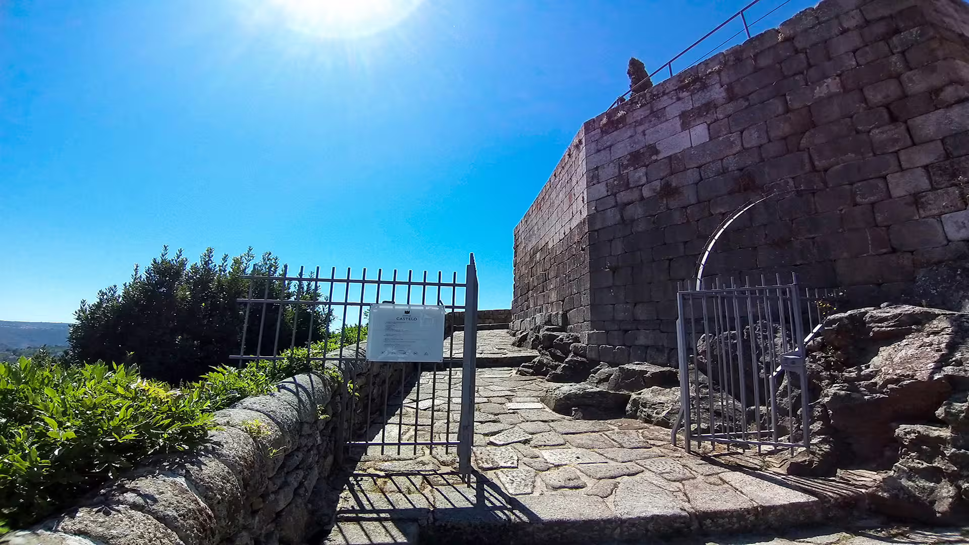 Stone pathway leading to historic castle entrance in Lamego under clear blue sky, on a private tour of the Dão wine region.