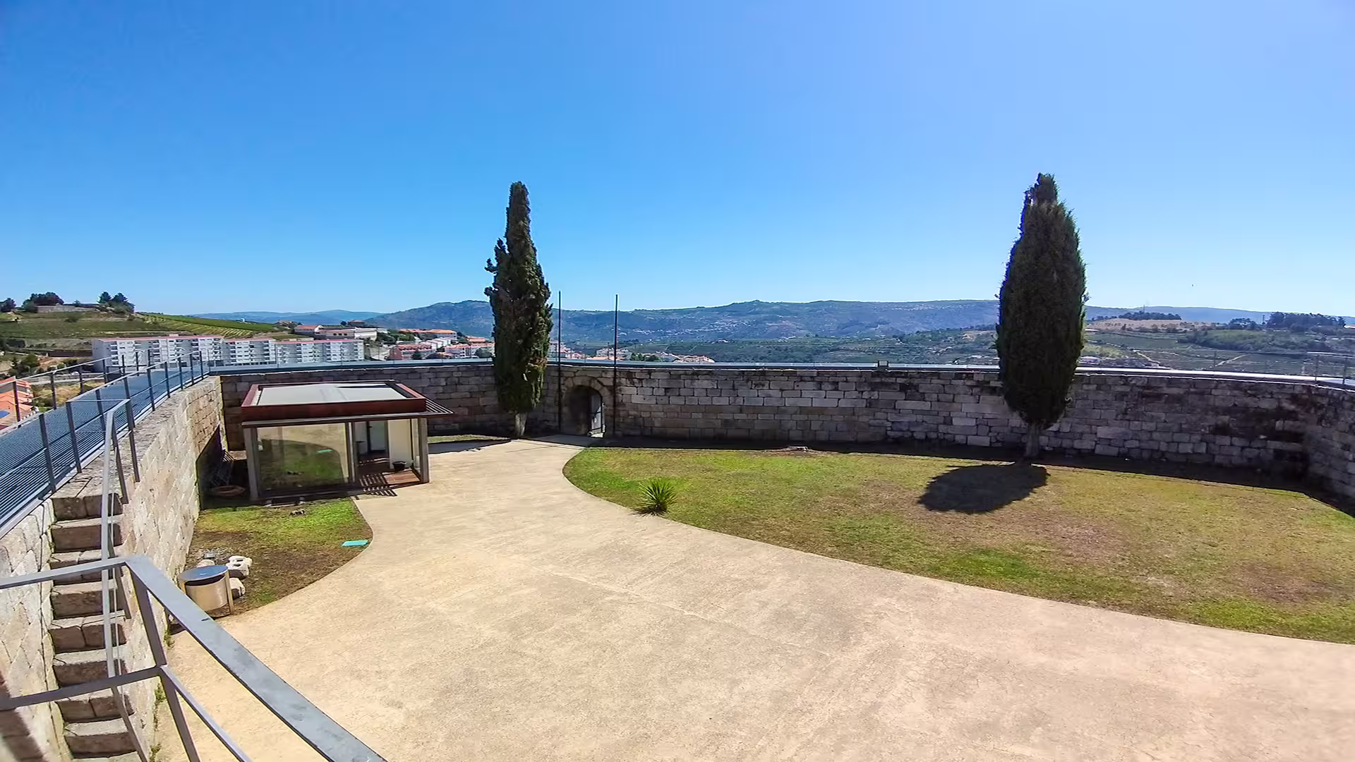Scenic view of Lamego fortress courtyard and distant hills, capturing the essence of the Dão wine region's beauty.