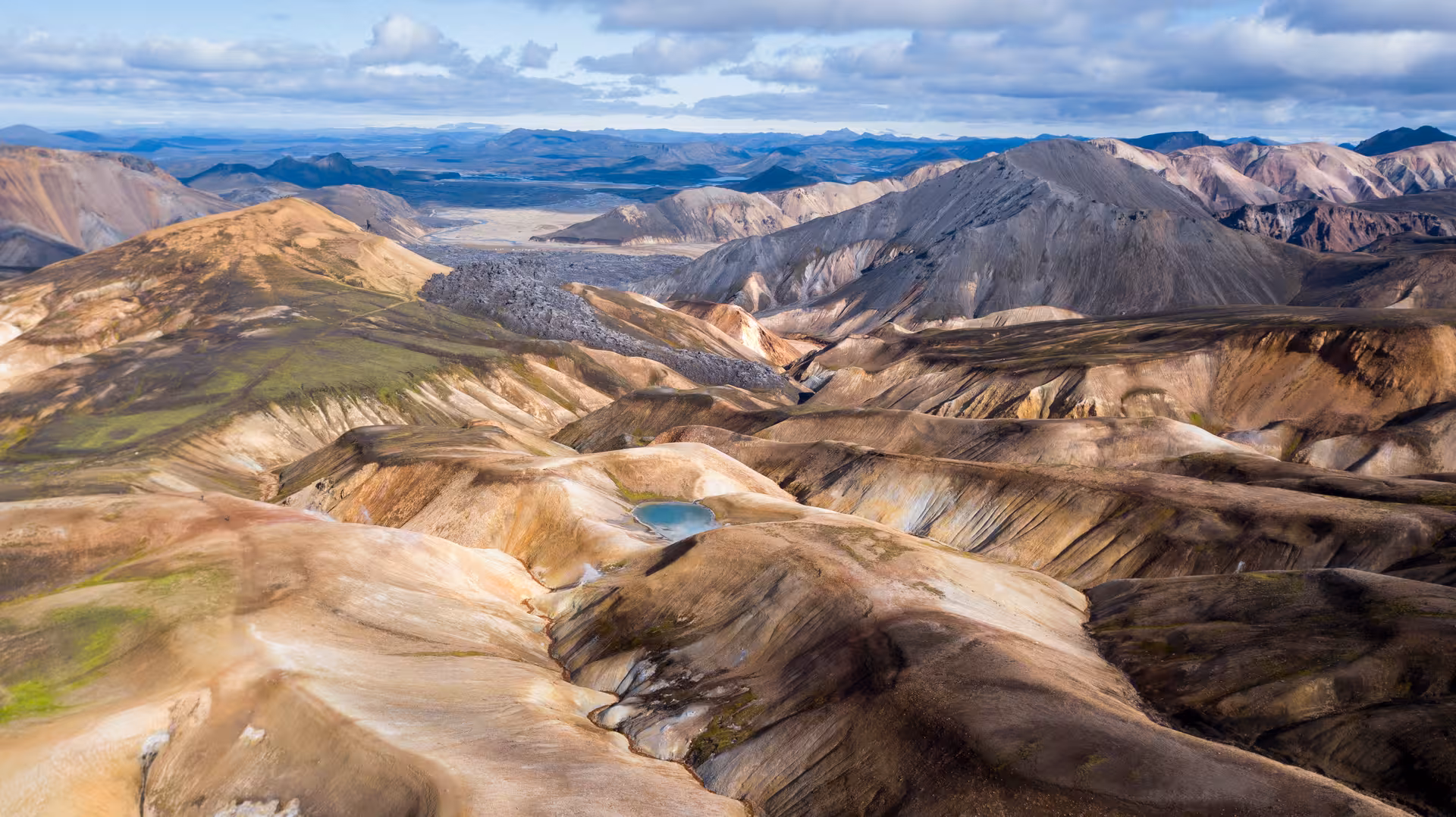 Aerial view of Landmannalaugar's rugged, multicolored mountains and geothermal landscapes for 4x4 exploration.