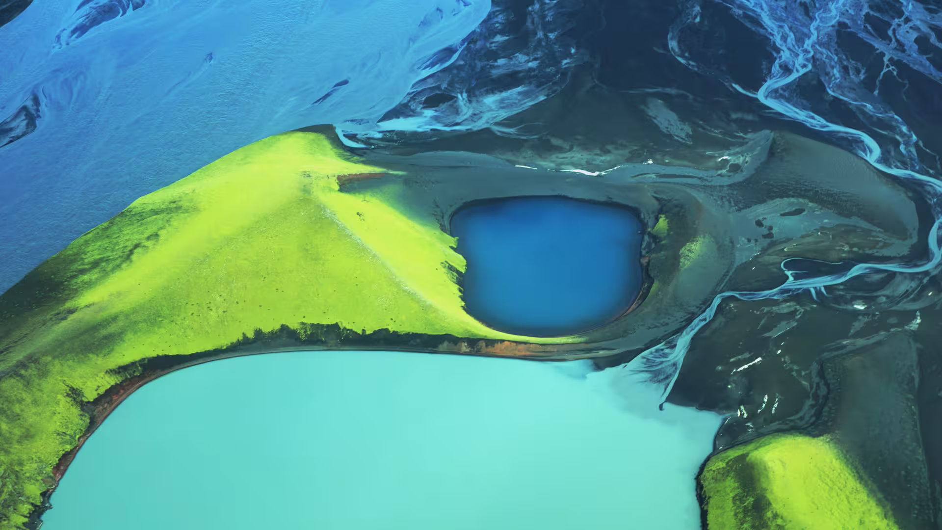 Aerial view of Landmannalaugar volcanic crater lake with vivid green moss and turquoise glacial rivers, Iceland