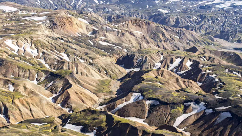 Aerial view of Landmannalaugar colorful rhyolite mountains with snow patches in Iceland highlands