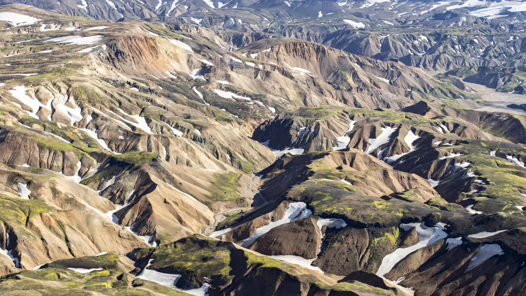 Aerial view of Landmannalaugar colorful rhyolite mountains with snow patches in Iceland