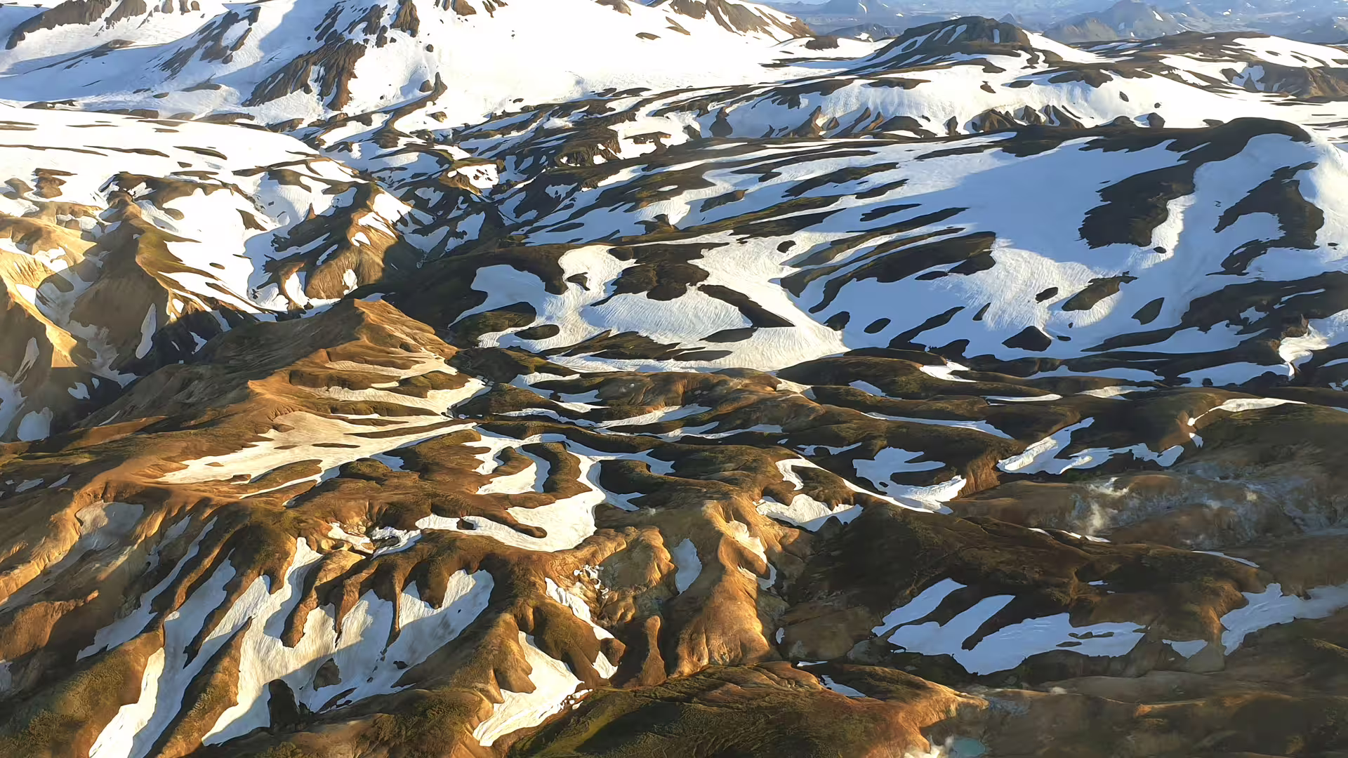 Aerial view of Landmannalaugar snow-patched rhyolite mountains in Iceland's highlands