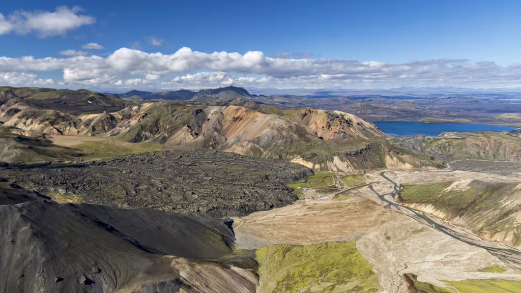 Aerial view of Landmannalaugar colorful rhyolite mountains, lava fields, and blue lake in Iceland