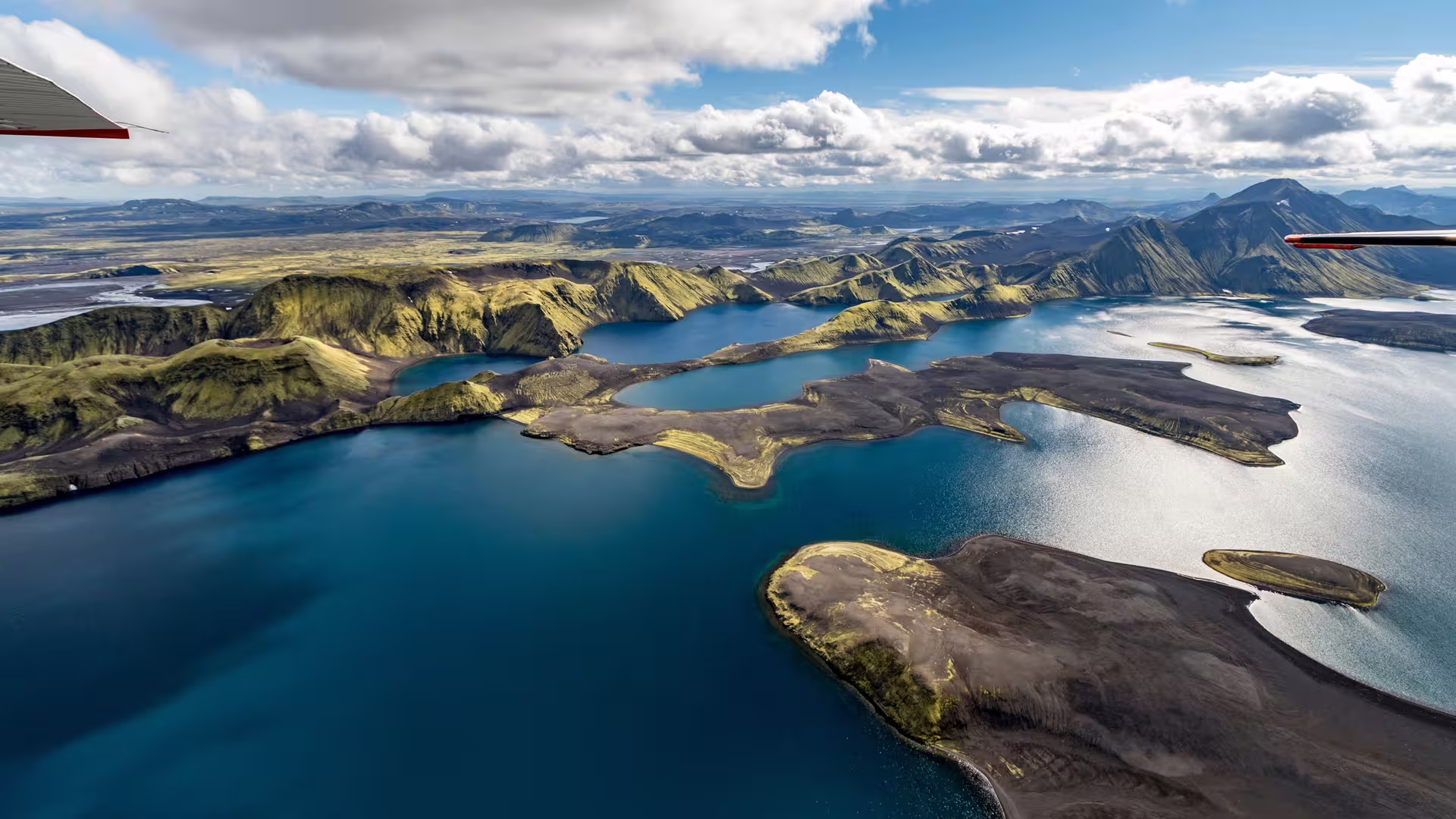 Aerial view of Landmannalaugar volcanic lakes and green mountains in Iceland from small airplane