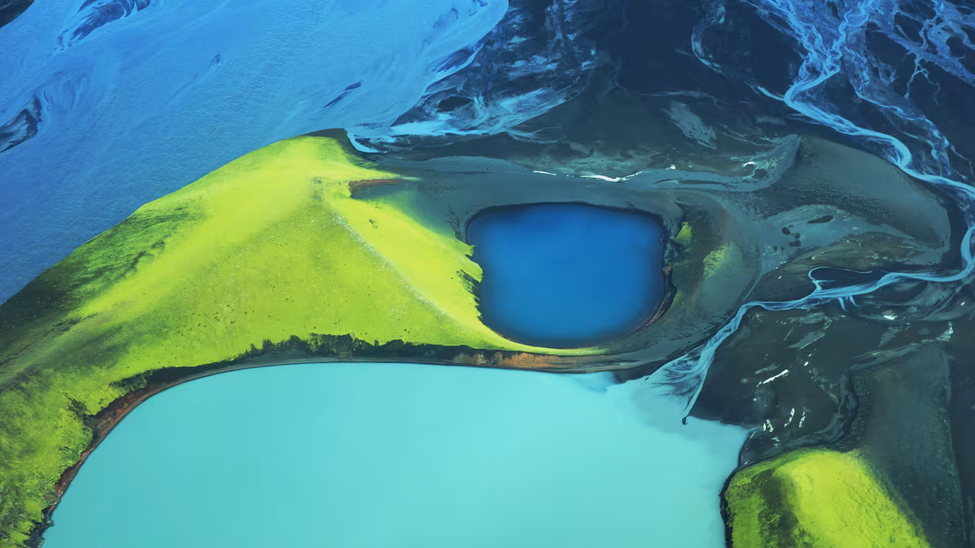 Aerial view of Landmannalaugar volcanic crater lake with vivid green hills and turquoise glacial waters, Iceland
