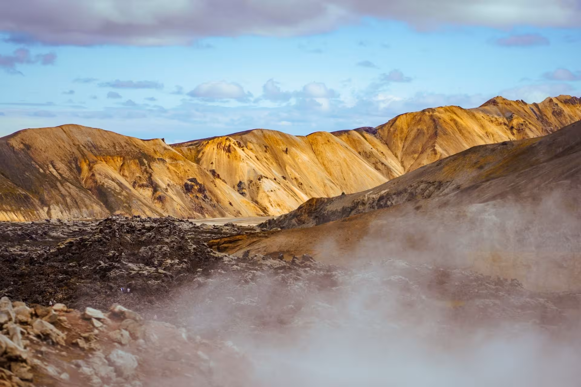 Geothermal steam rising over colorful rhyolite mountains at Landmannalaugar highlands Iceland