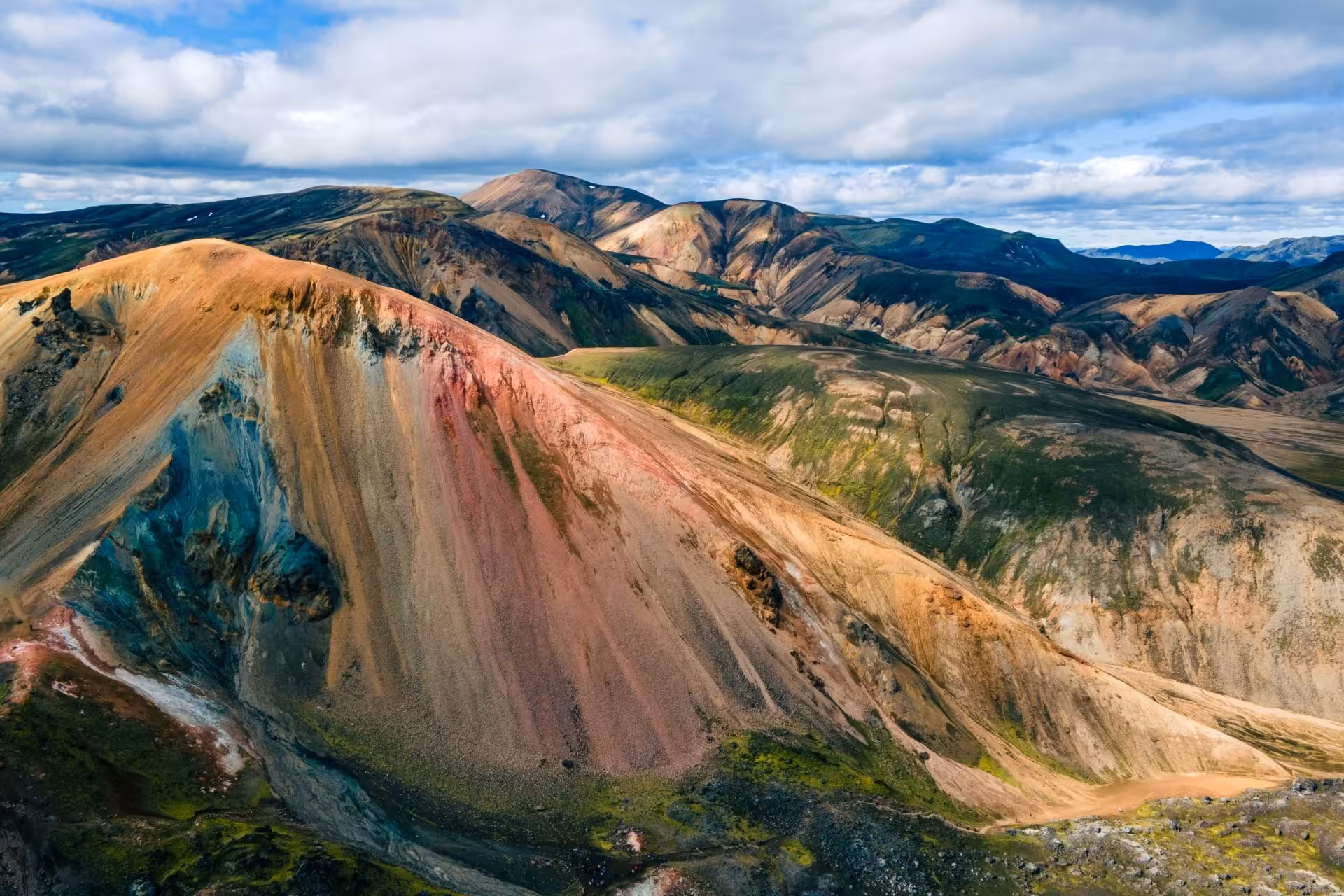 Colorful rhyolite mountains of Landmannalaugar Iceland Highlands with vivid red, teal, and orange volcanic slopes