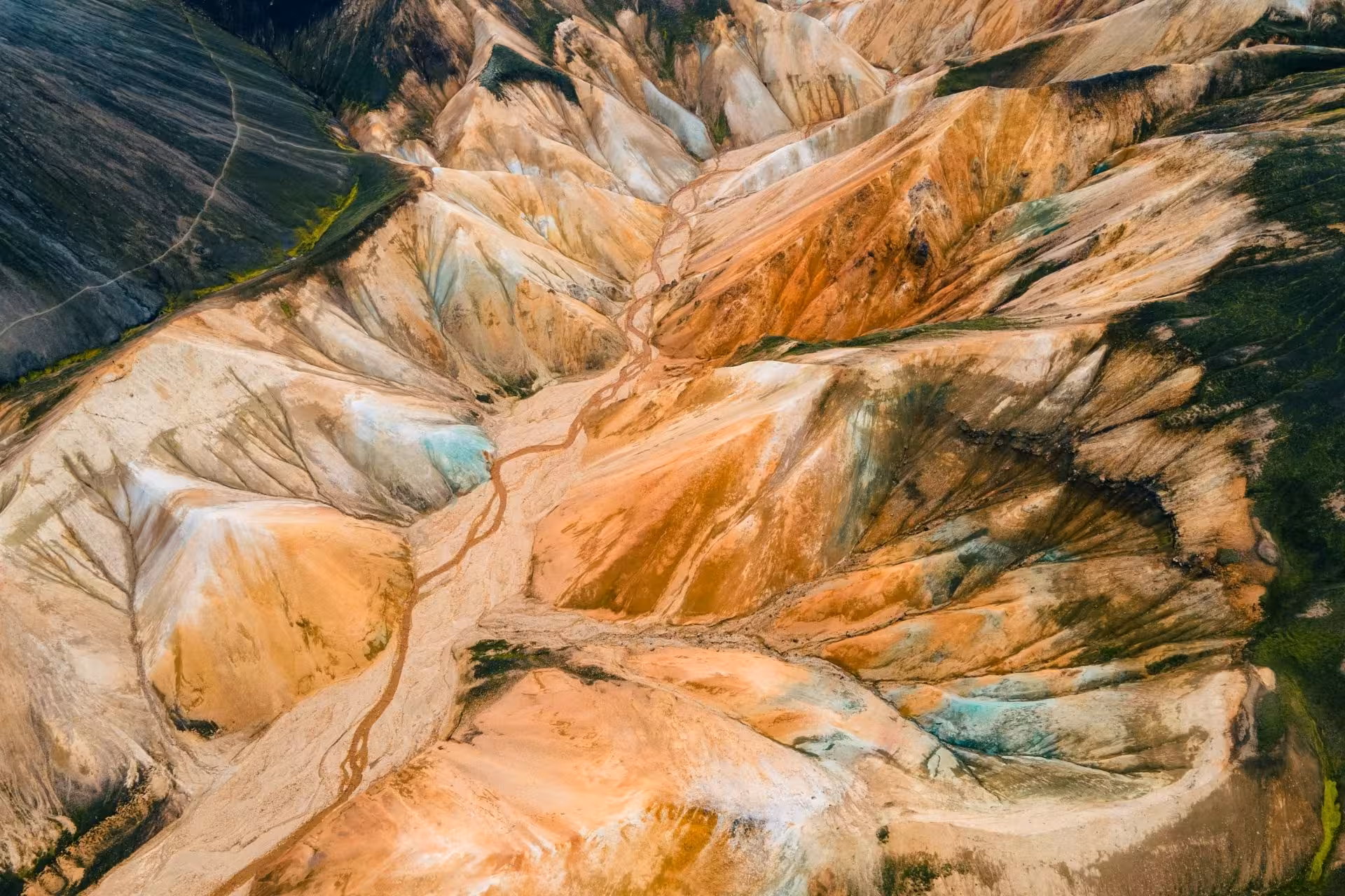Aerial view of colorful rhyolite mountains at Landmannalaugar Iceland with orange and teal mineral streaks