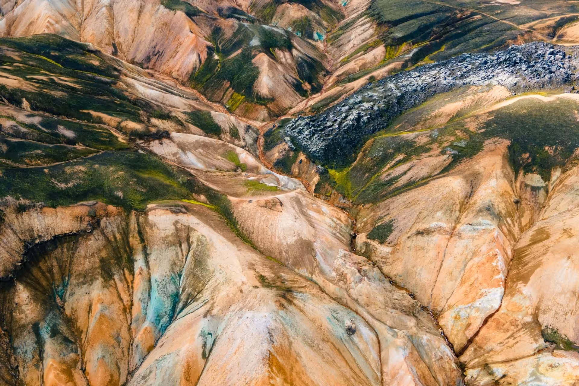 Aerial view of Landmannalaugar colorful rhyolite mountains with lava fields and green moss, Iceland Highlands
