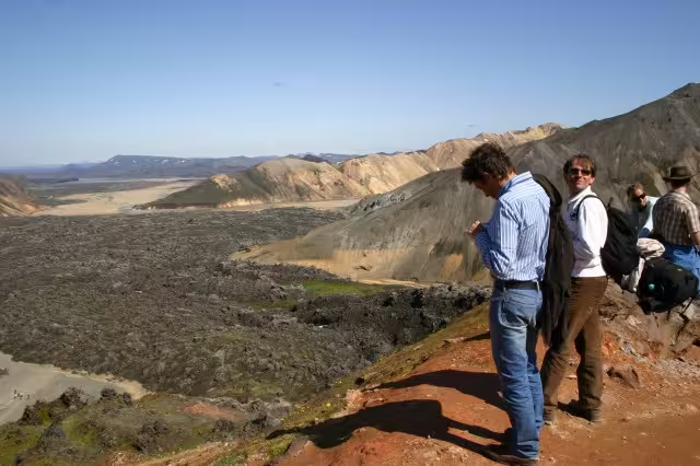 Tourists overlooking Landmannalaugar lava fields and colorful rhyolite mountains on a super jeep tour