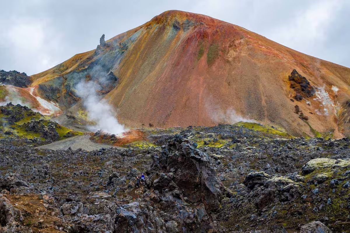 Colorful rhyolite mountains with geothermal steam vents and lava fields at Landmannalaugar, Iceland