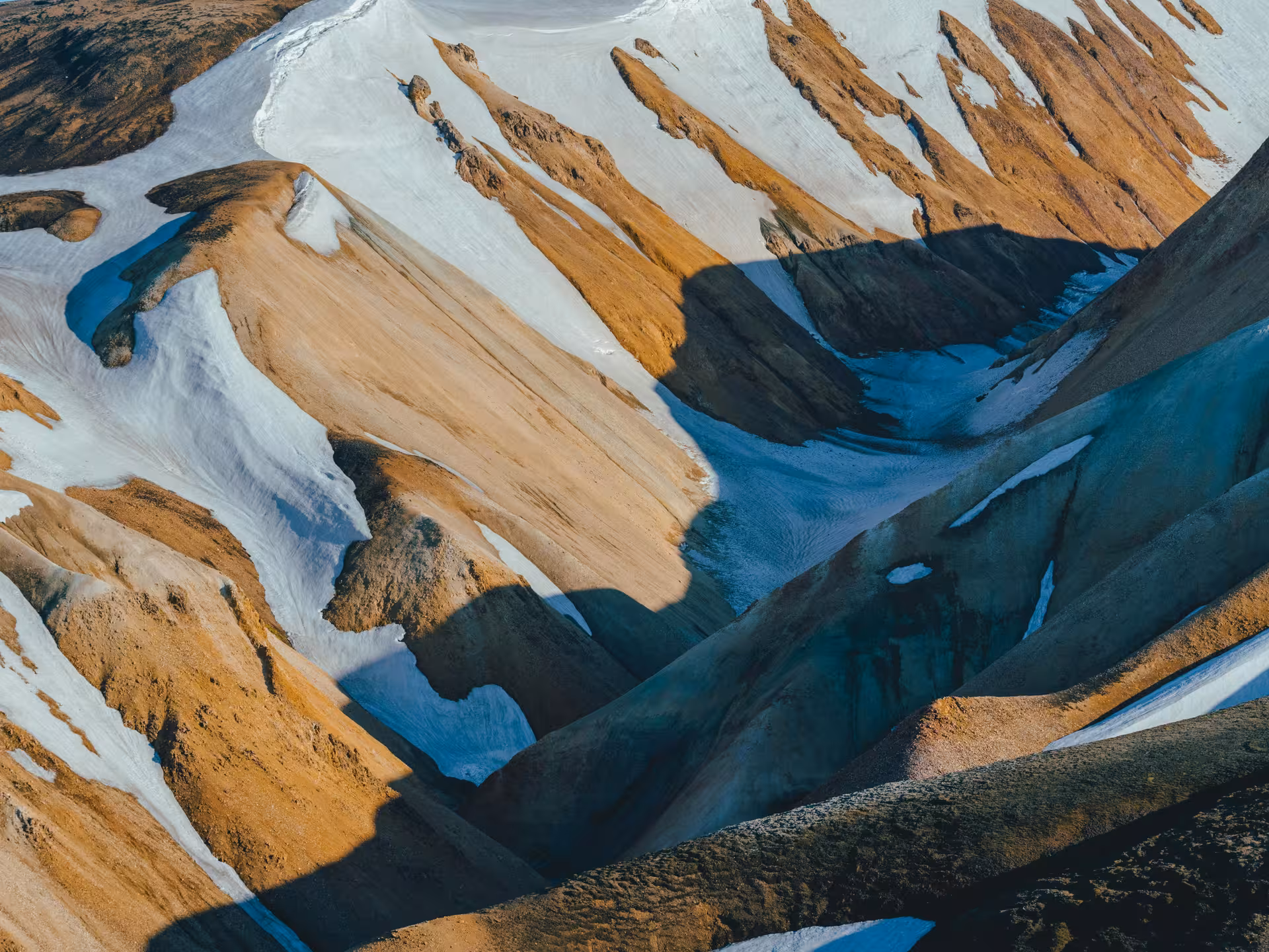 Aerial view of Landmannalaugar colorful rhyolite mountains with snow patches in Iceland