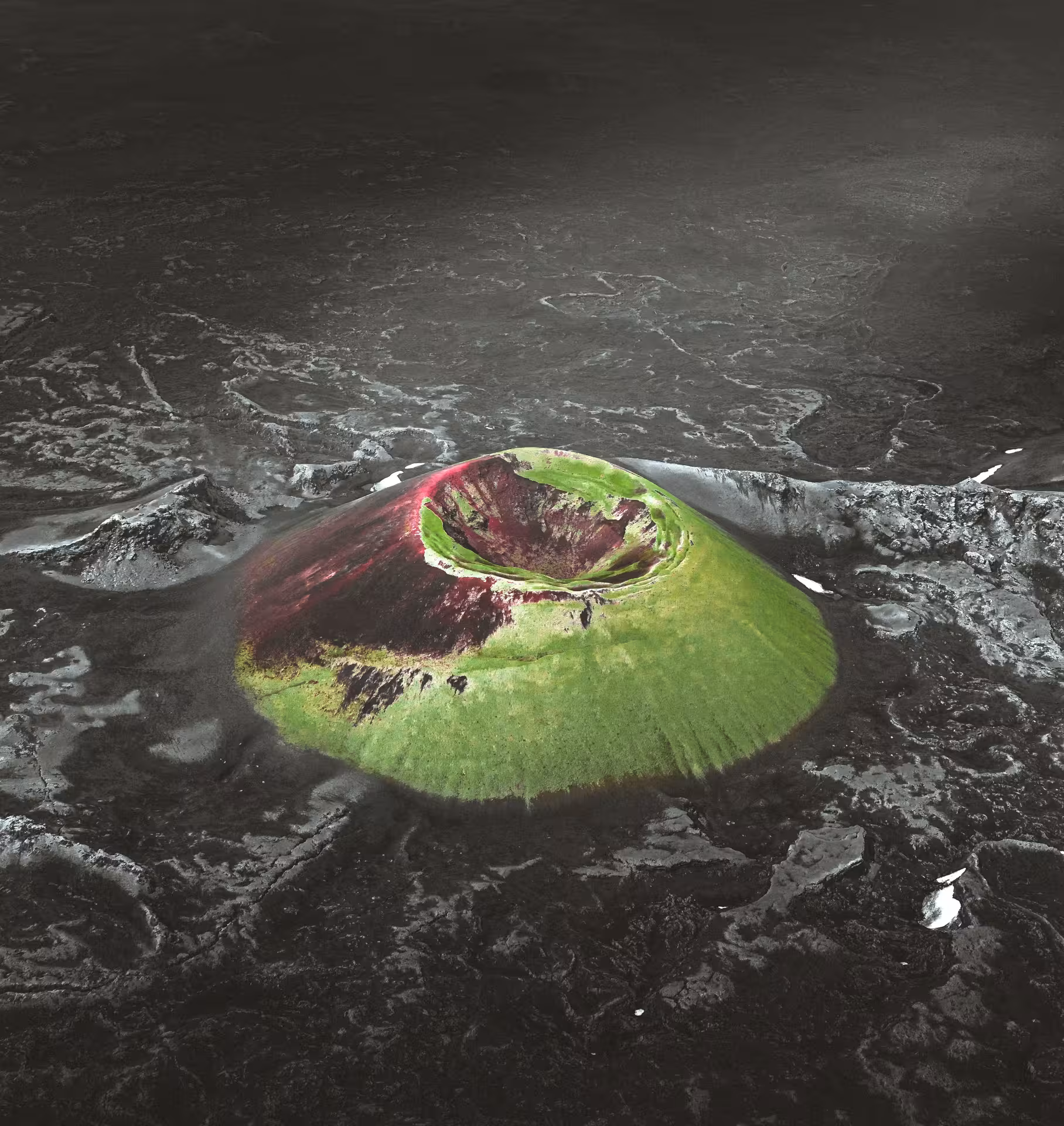 Aerial view of a colorful volcanic crater with green moss and red rock surrounded by dark lava fields in Iceland