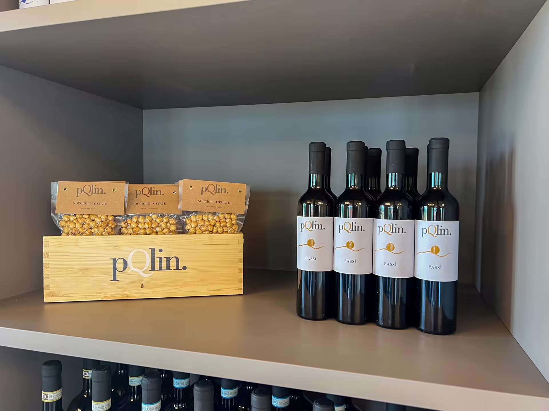 Close-up of wine bottles and gourmet snacks on display, showcasing rustic charm for Langhe wine tasting tours.
