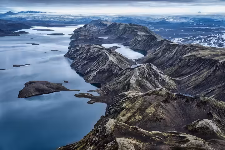Aerial view of Langisjor Lake surrounded by rugged volcanic mountains in Iceland's highlands
