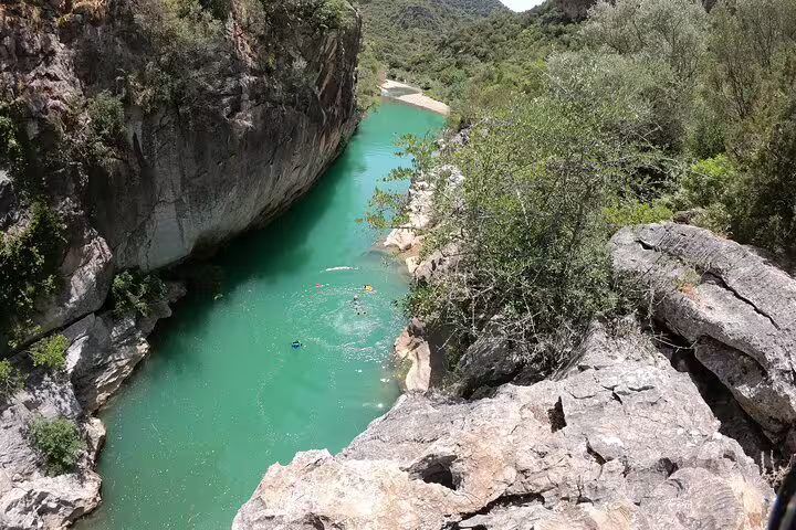 Stunning aerial view of turquoise river winding through Las Buitreras Canyon guided tour in Málaga Province