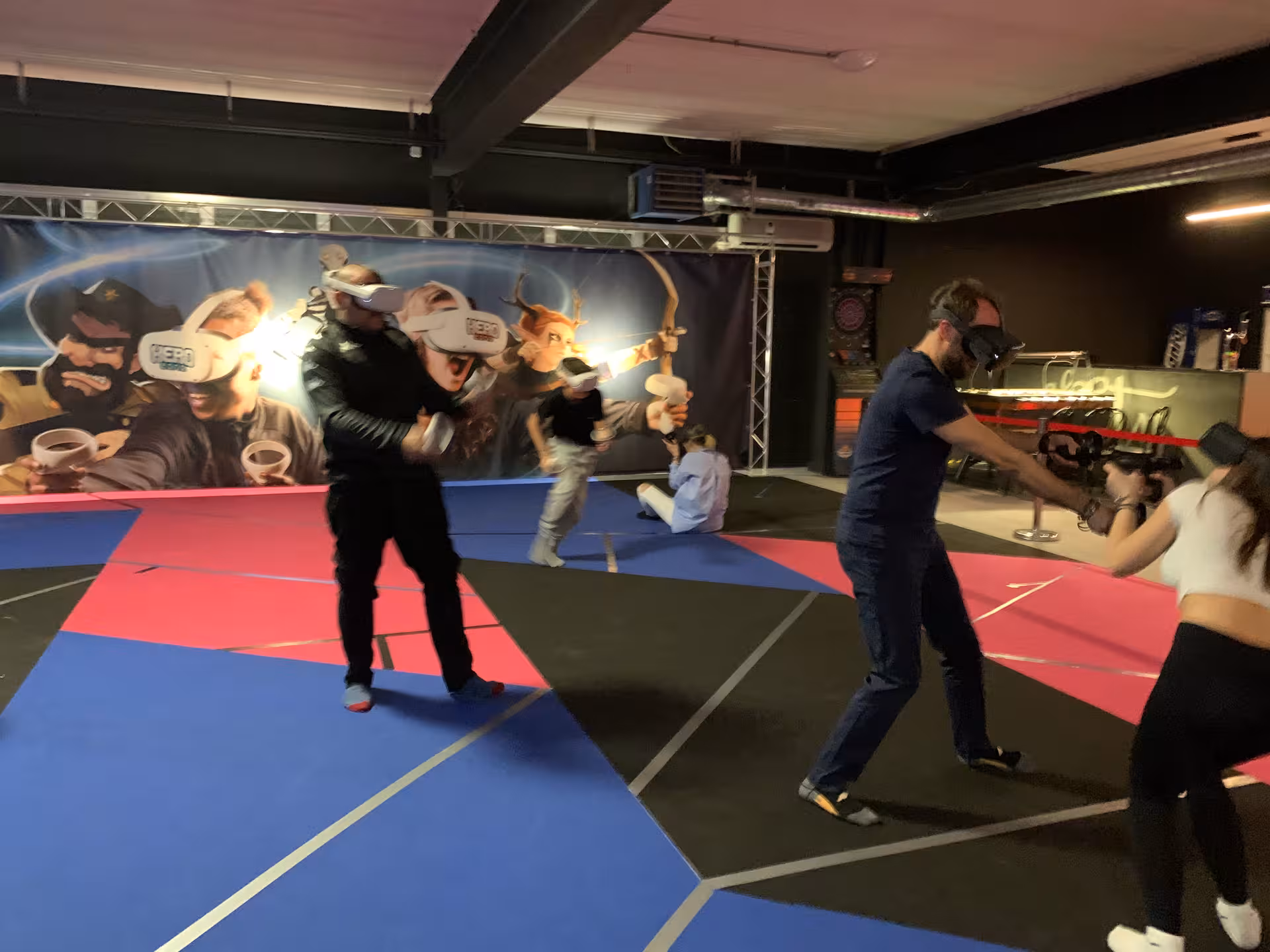 Friends battle in Laser Game VR 18 with VR headsets and blasters, indoor free-roam multiplayer action arena