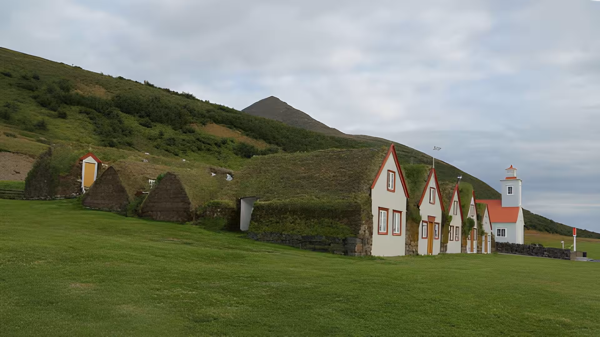 Traditional Icelandic turf houses with white and red gabled facades at Laufas museum near Akureyri