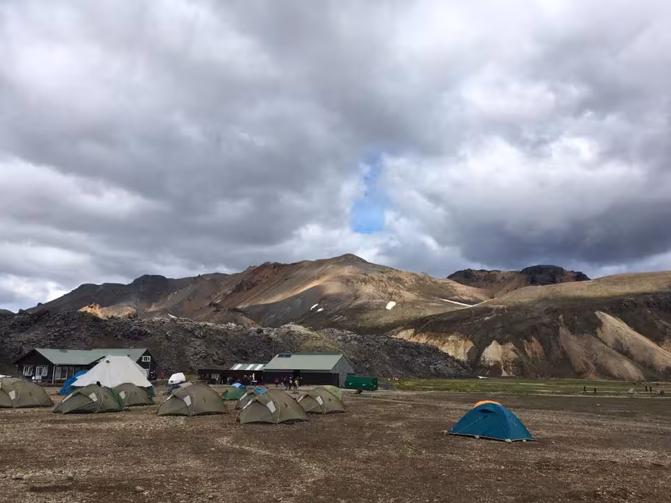 Landmannalaugar campsite with tents and mountain huts on Laugavegur Trail, Iceland