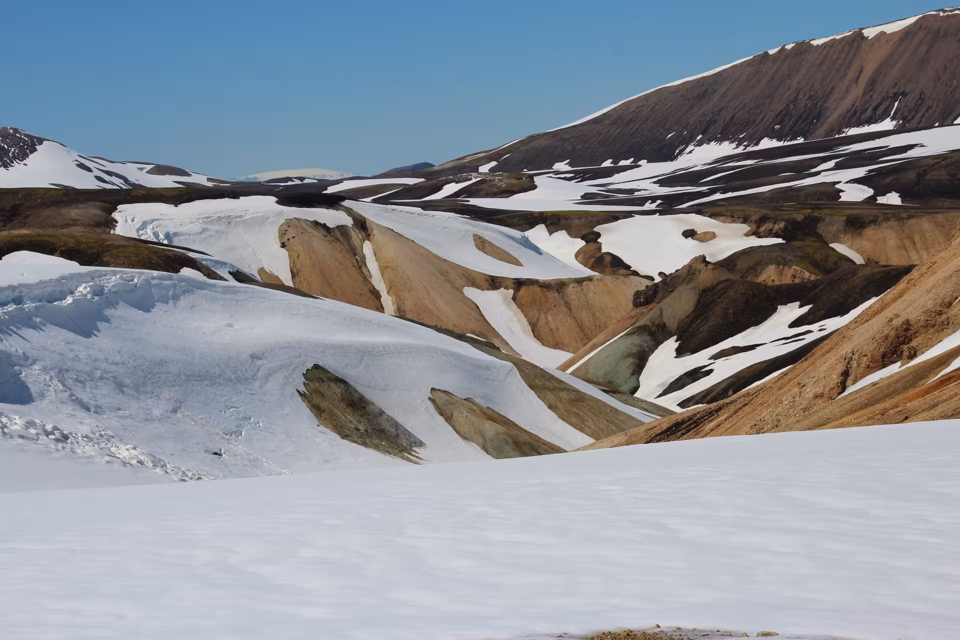 Colorful rhyolite mountains and snow fields along the Laugavegur Trek in Iceland's highlands