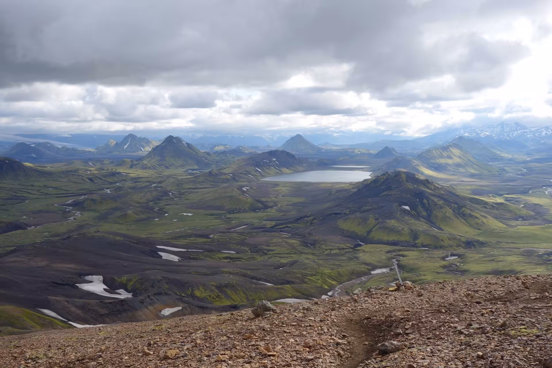 Panoramic view of green volcanic highlands and lake from Laugavegur trek, Iceland