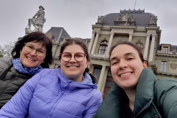 Smiling travelers at Palais de Rumine on a Lausanne city center scavenger hunt self-guided tour