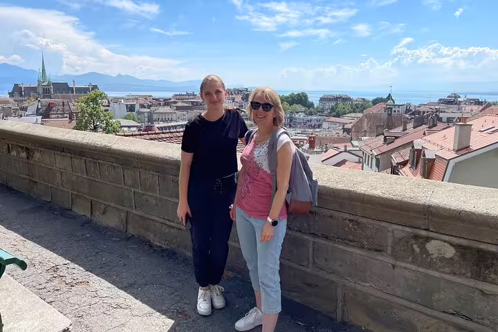 Travelers enjoy Lausanne old town and Lake Geneva views on a city center scavenger hunt walking tour
