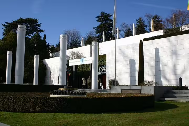 Olympic Museum entrance with white columns and Olympic rings sign in Lausanne Switzerland