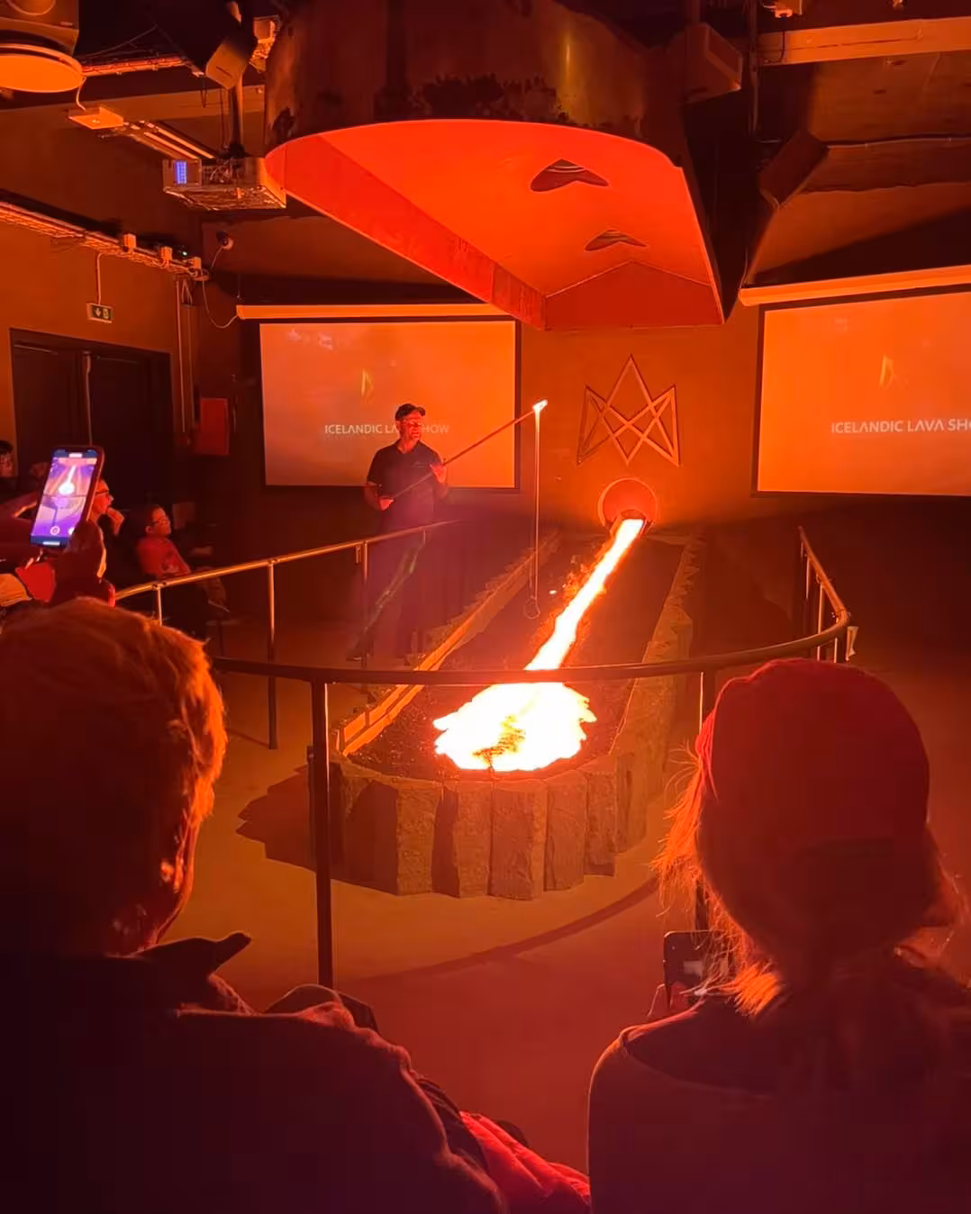Visitors watching molten lava flow inside the Lava Show in Reykjavík, one of Iceland’s most unique volcanic experiences.