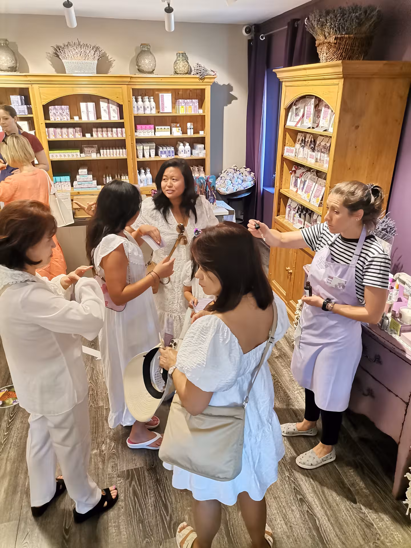 Visitors join a lavender experience workshop in a Provence boutique, sampling oils and local products