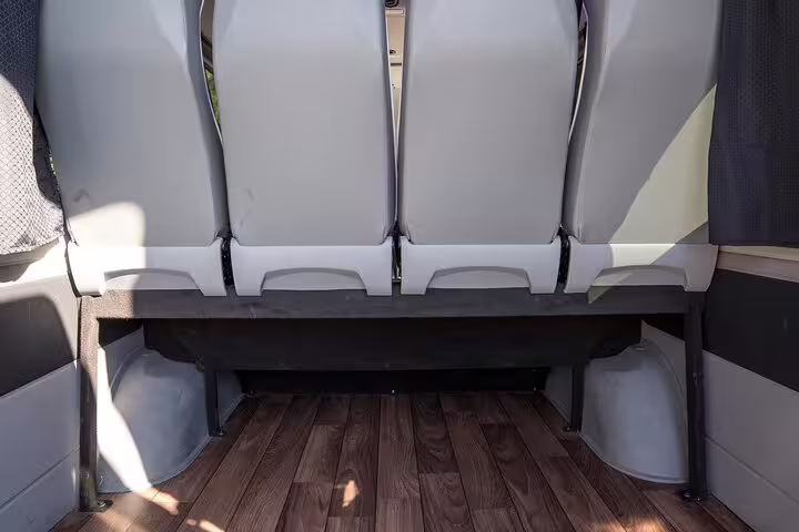 Spacious luggage area in private transfer van from Lavrio port hotels to Athens airport with ample legroom