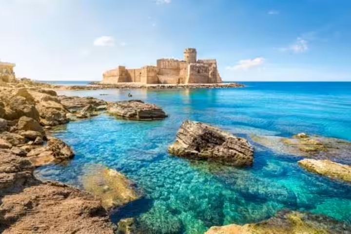 Le Castella fortress on a rocky islet surrounded by turquoise Ionian Sea waters, a signature stop on the Legendary Calabria Tour