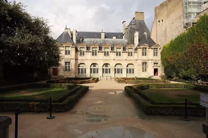 Elegant historic mansion and formal garden courtyard in Le Marais, Paris on a private guided walking tour
