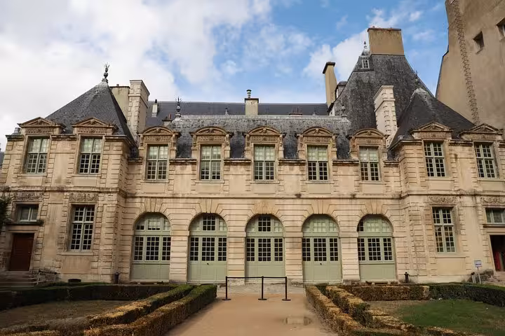 Close view of a classic Le Marais hôtel particulier facade in Paris, featured on a private walking tour