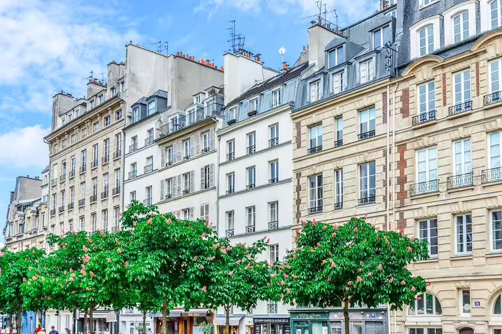 Classic Haussmann buildings and tree-lined boulevard in Le Marais neighborhood, Paris
