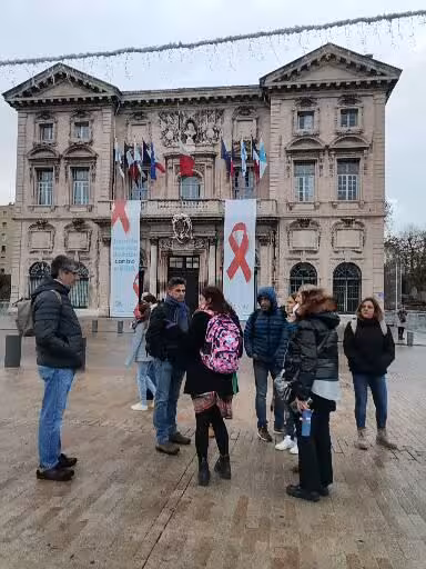 Tour group gathered before Marseille city hall near Le Panier, starting a guided walking tour of the oldest neighborhood