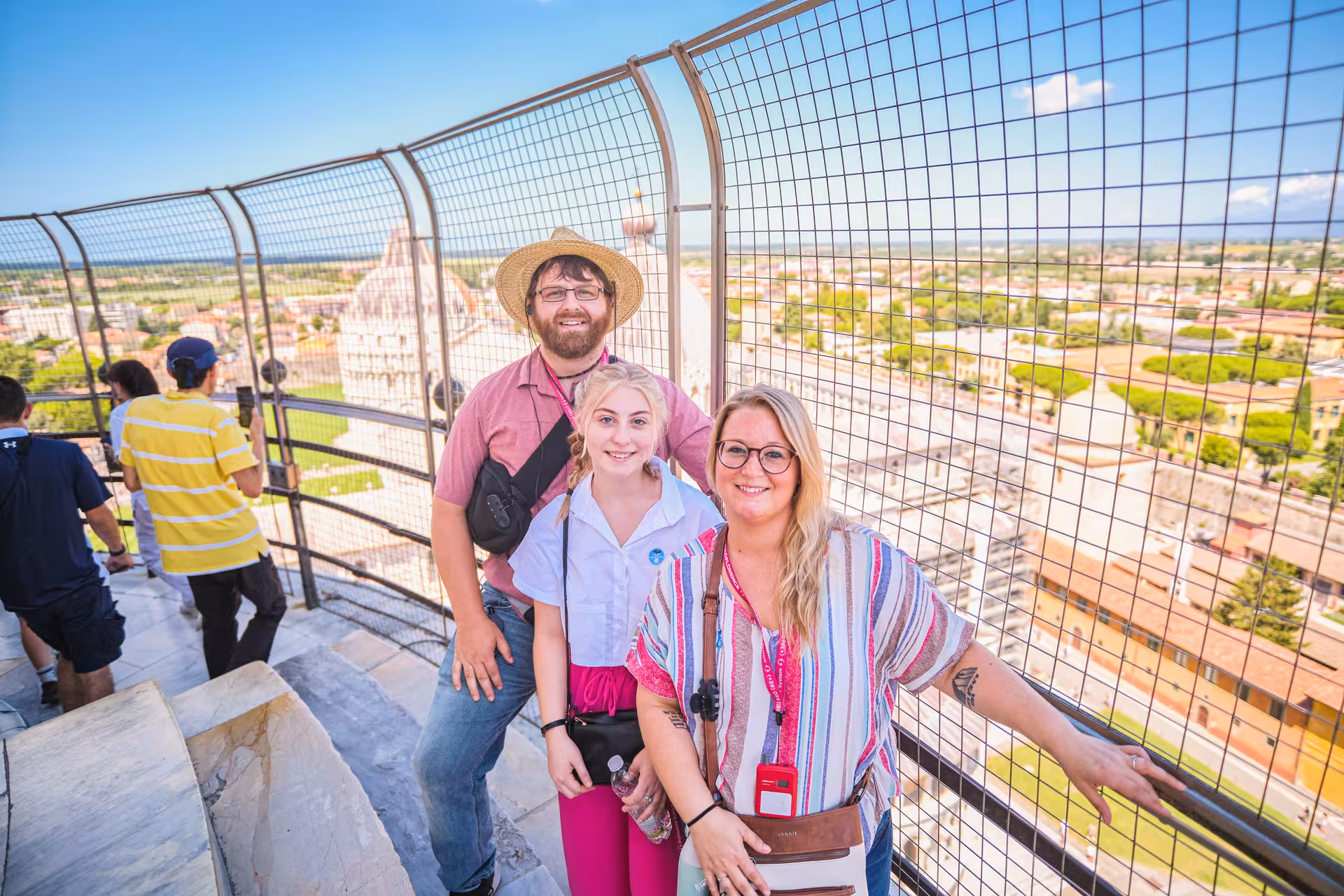 Tourists enjoying panoramic views from the Leaning Tower of Pisa, part of a Florence day trip experience.