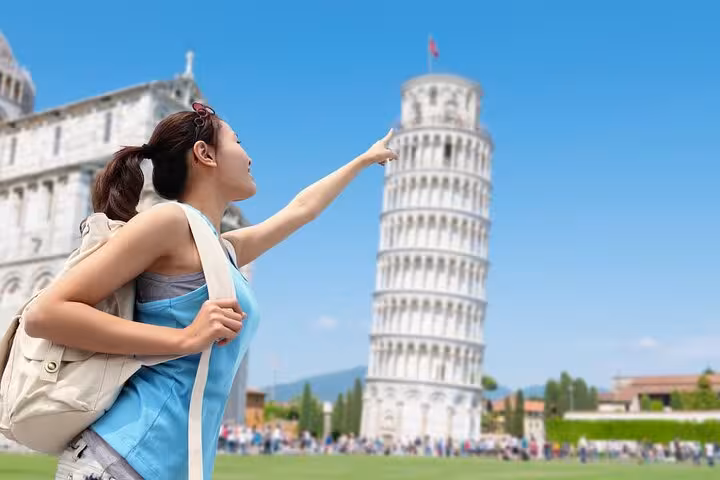 Tourist enjoying the iconic Leaning Tower of Pisa on a private half day trip from Florence with skip the line access.