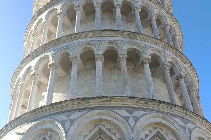 Close-up of Leaning Tower of Pisa marble arches and columns, highlighting architecture on private Tuscany day trip