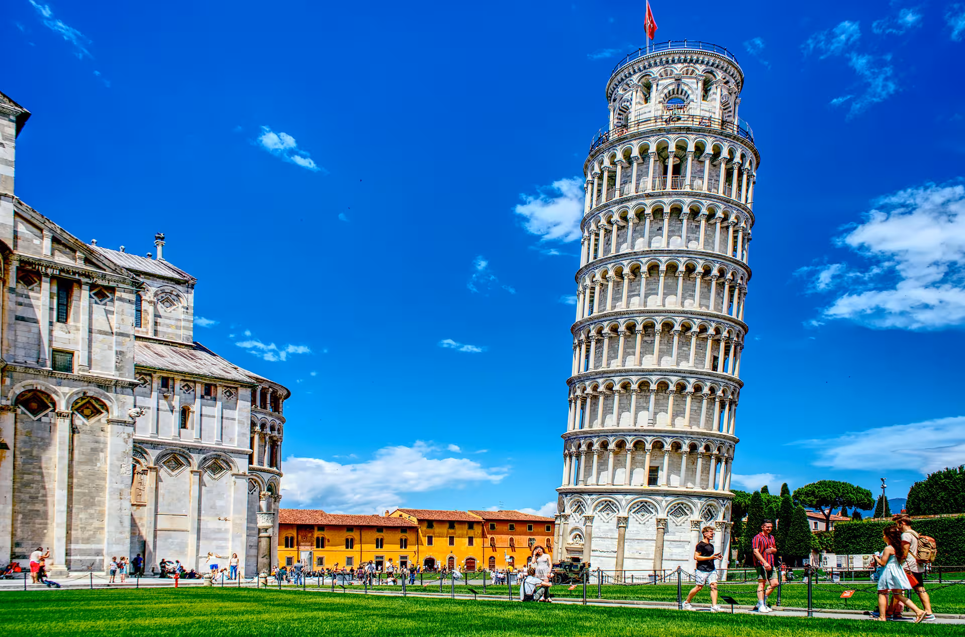 Explore the iconic Leaning Tower of Pisa under clear blue skies on your Pisa & Tuscany Beach Escape adventure.