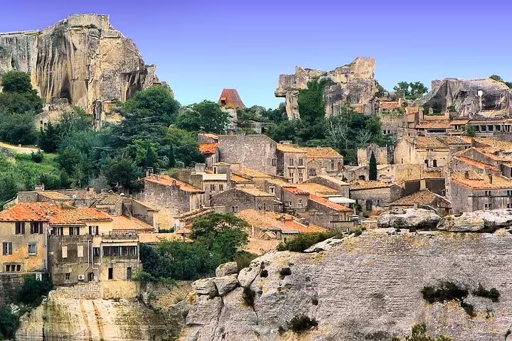 Scenic view of Les Baux de Provence's ancient cliffside village with rugged stone architecture.