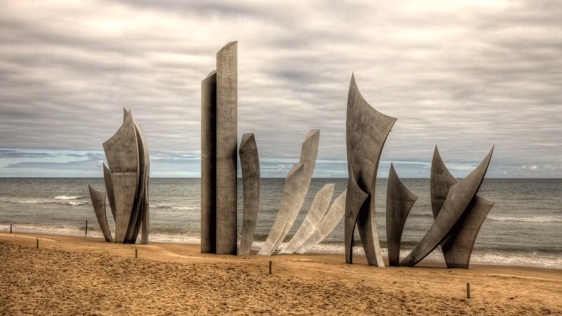 Les Braves sculpture on Omaha Beach, Normandy D-Day landing site visited on customizable small-group minivan day trip