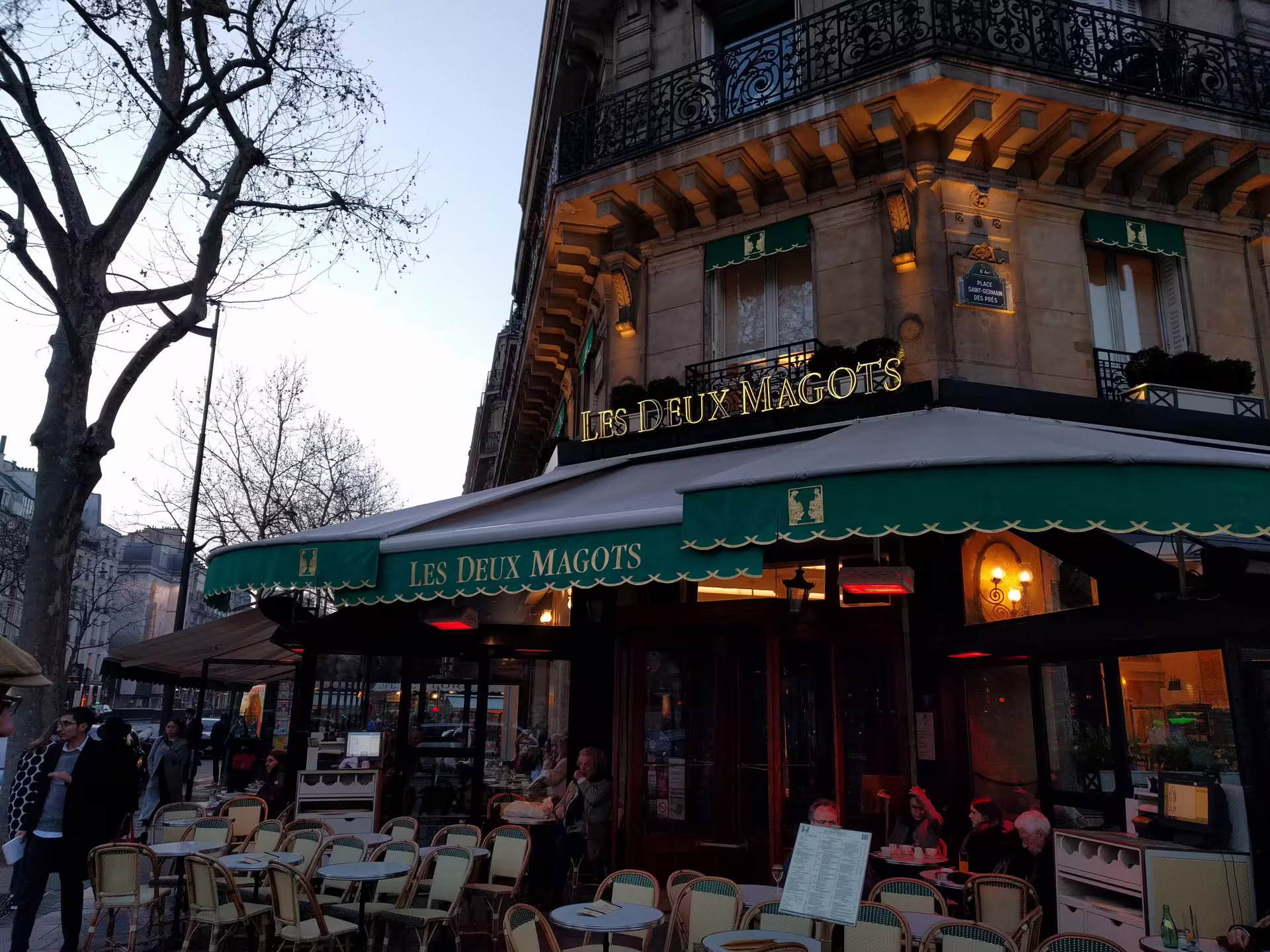 Les Deux Magots café terrace at dusk in Saint-Germain-des-Prés, Paris
