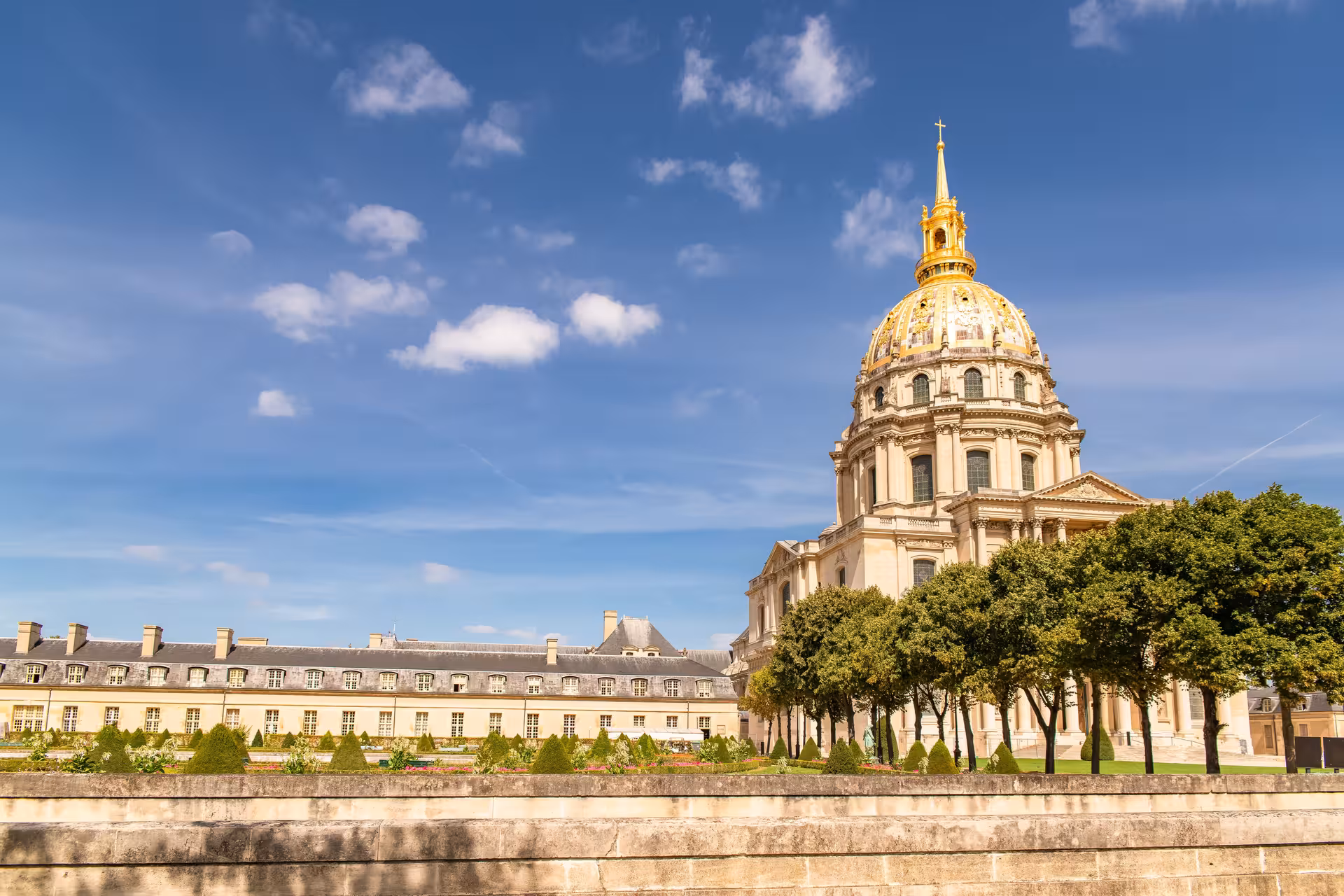 Les Invalides golden dome and manicured gardens in Paris on a sunny day