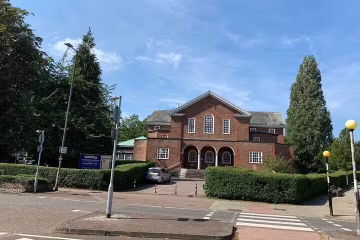 Historic red brick building with arched entrance in Letchworth Garden City on a sunny day