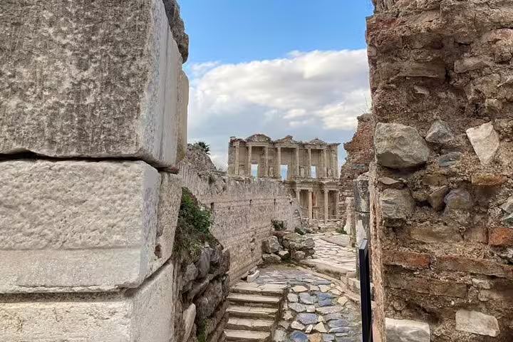 Stone pathway leading to the Library of Celsus ruins in ancient Ephesus on a private guided tour from Kusadasi