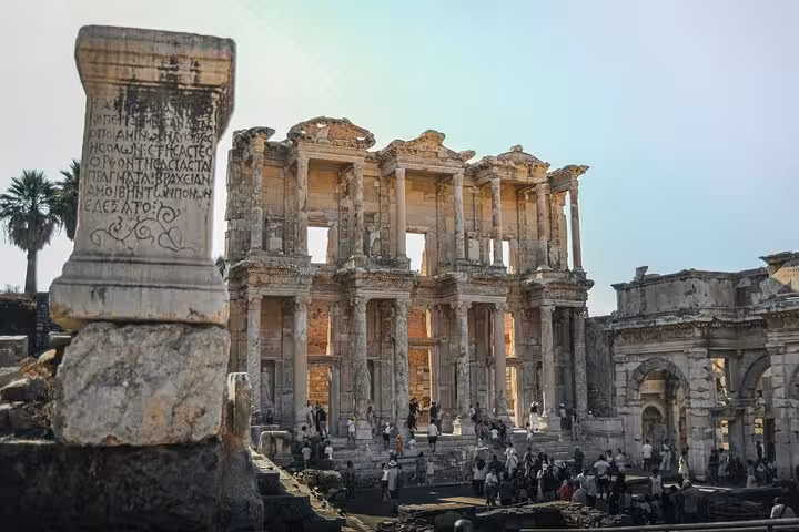Library of Celsus ruins in Ephesus on a private tour from Izmir Cruise Port, with visitors in the courtyard